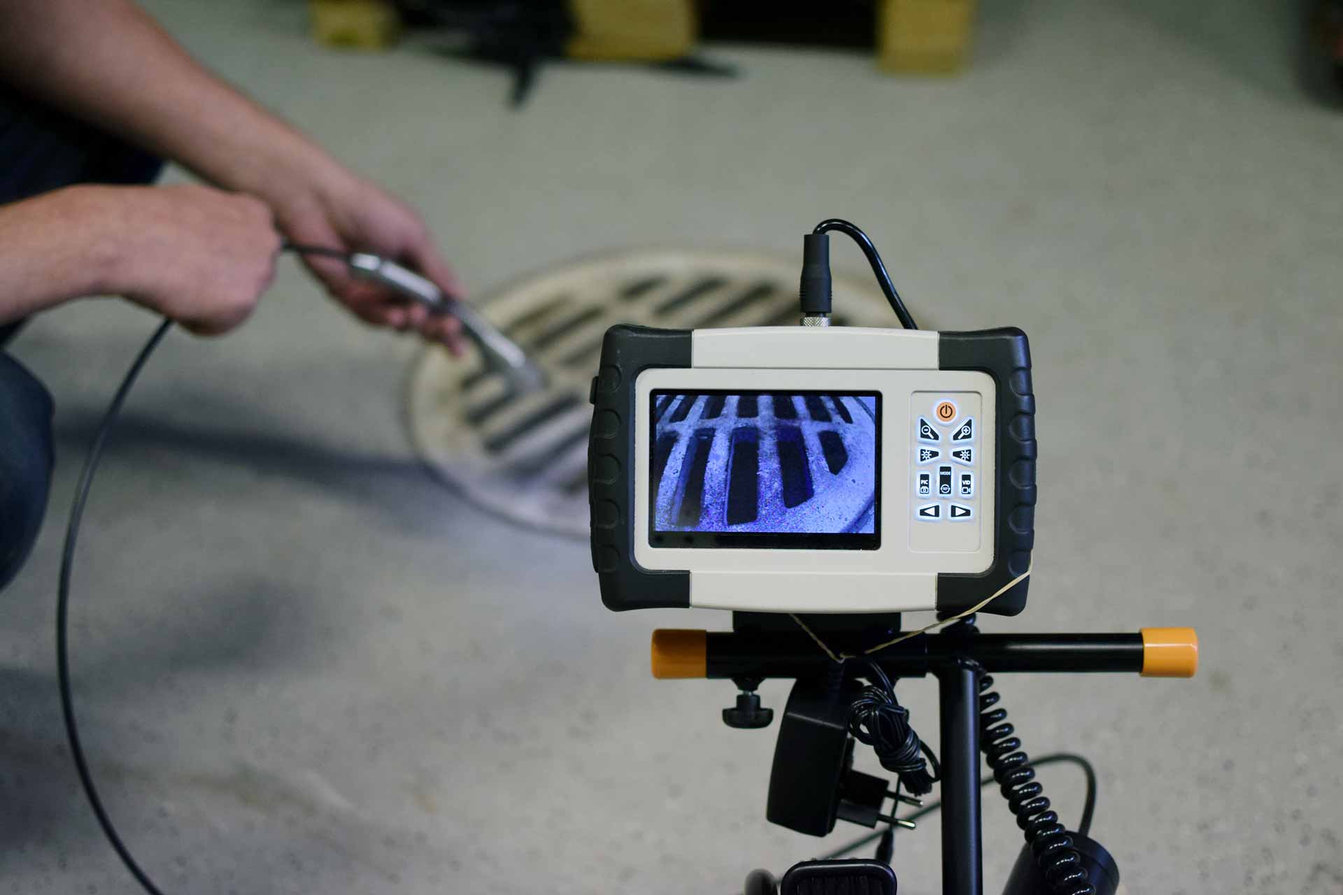 Inspecting a sewer grate with a video pipe inspection camera